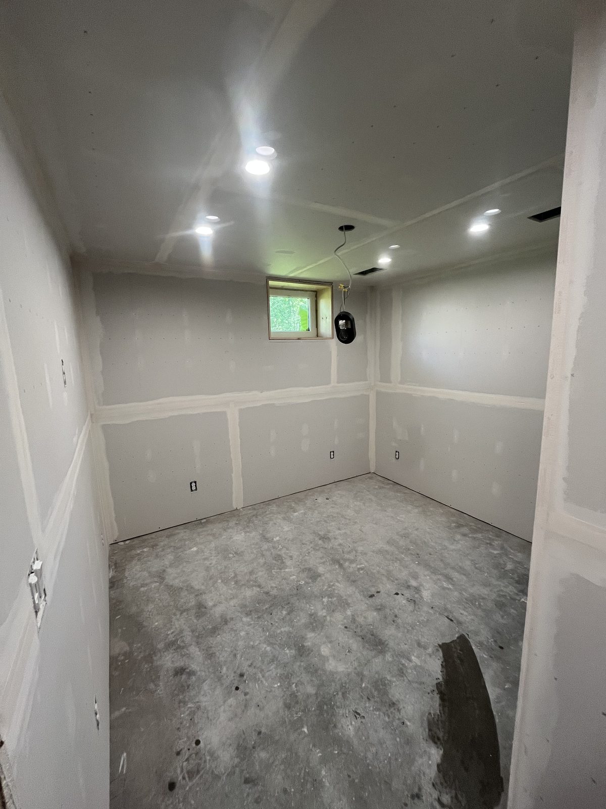 Hung and taped drywall with recessed lighting in a basement renovation, Central NY
