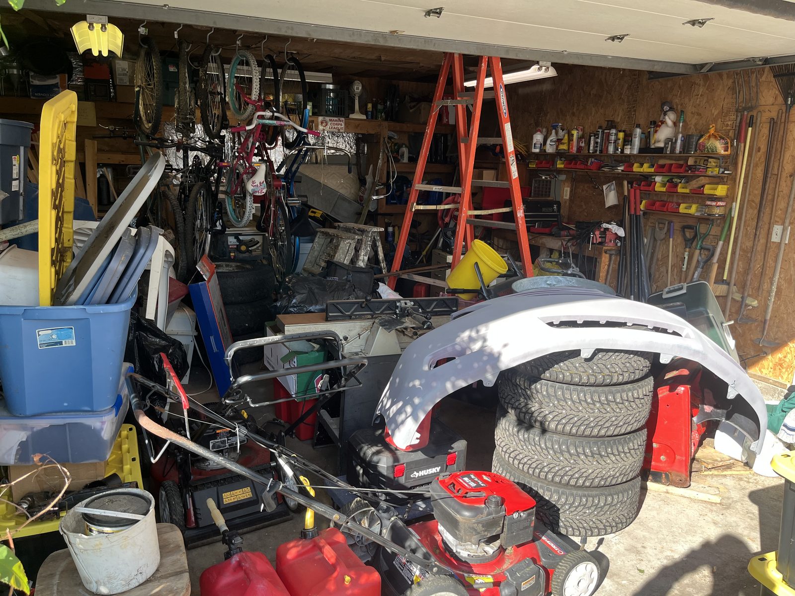 Garage before clean-out — packed with tools, tires, and clutter