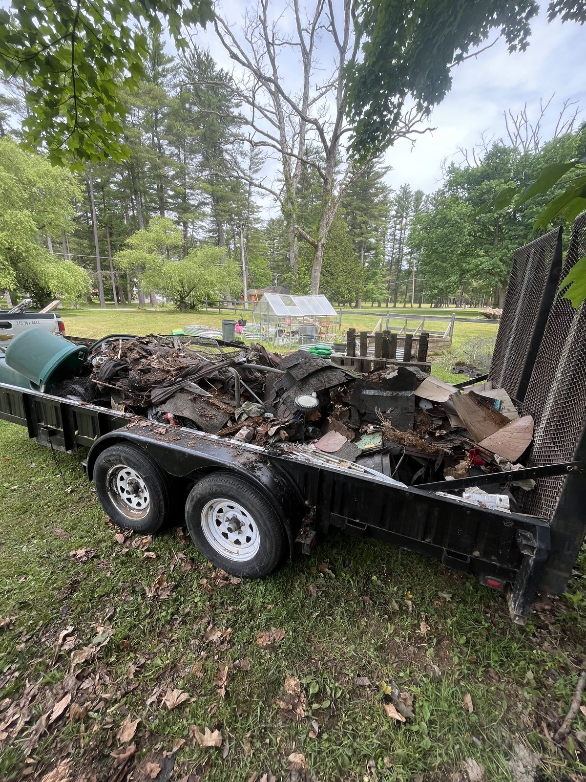 Yard debris loaded and hauled away on trailer in Central NY